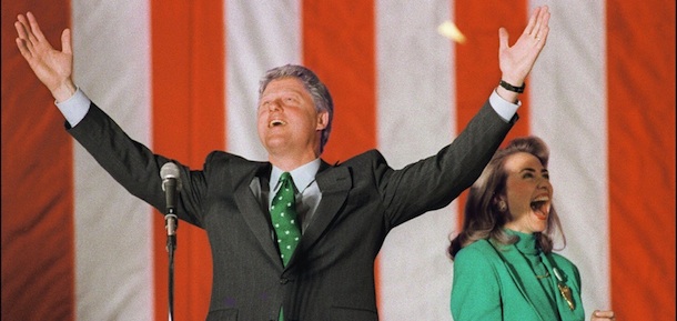 CHICAGO, UNITED STATES: Democratic presidential candidate Bill Clinton in a picture dated 17 March 1992 in Chicago waves to the crowd with wife Hillary during his victory party after winning the Illinois primary. (Photo credit should read TIM CLARY/AFP/Getty Images)