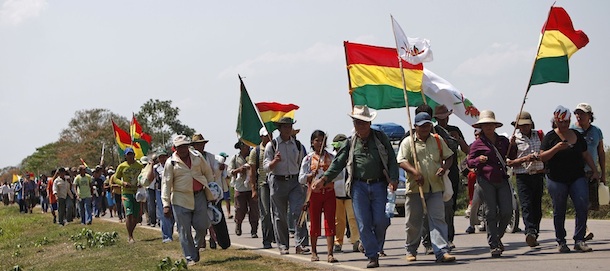 Members of the Moxos ethnic group march during a protest in Trinidad, Bolivia, Monday Aug. 15, 2011. Indigenous and environmentalists groups began Monday a 846-kilometer march from Trinidad to La Paz to protest the construction of a 300-kilometer highway aimed to connect Brazil to Pacific ports in Chile and Peru, and that will plow through a nature preserve, home to 15,000 natives and to endangered fresh water dolphins and blue macaws. (AP Photo/Juan Karita)