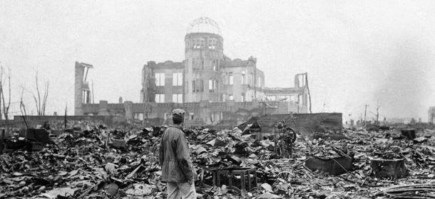 ** ADVANCE FOR SUNDAY, AUG. 8, 2010 ** FILE - This Sept. 8, 1945 picture shows an allied correspondent standing in the rubble in front of the shell of a building that once was a movie theater in Hiroshima, Japan, a month after the first atomic bomb ever used in warfare was dropped by the U.S. on Monday, Aug. 6, 1945. A movement is growing worldwide to abolish nuclear weapons, encouraged by President Barack Obama's endorsement of that goal. But "realists" argue that more stability and peace must first be achieved in the world. (AP Photo/Stanley Troutman)