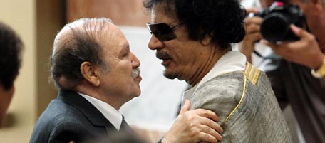 Libyan leader Moamer Kadhafi (R) embraces Algerian President Abdelaziz Bouteflika during the opening session of the Arab League Extraordinary Summit in the Libyan coastal city of Sirte on October 9, 2010. AFP PHOTO/KHALED DESOUKI (Photo credit should read KHALED DESOUKI/AFP/Getty Images)