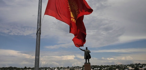 The Kyrgyz national flag flies at half staff in front of the statue of of the Soviet founder Vladimir Lenin on a central square in the southern Kyrgyz city of Osh, Kyrgyzstan, Wednesday, June 16, 2010, marking three national day of mourning after violence in Kyrgyz towns Osh and Jalal Abad. (AP Photo/Alexander Zemlianichenko)