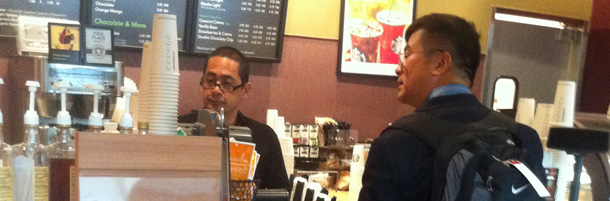 In this photo taken Friday Aug. 12, 2011 by ZhaoHui Tang, a Washington state businessman, Gary Locke, the new U.S. ambassador to China is shown carrying his own backpack and ordering his own coffee at Seattle-Tacoma International Airport. Tang was flying from Seattle to Silicon Valley last Friday when he spotted former Washington Gov. Gary Locke, who is the first Chinese-American ambassador to China. Tang took a picture with his iPhone and uploaded it right away to the China social media network Sina Weibo. The photo has been reposted about 40,000 times generating thousands of comments. (AP Photo/ZhaoHui Tang)