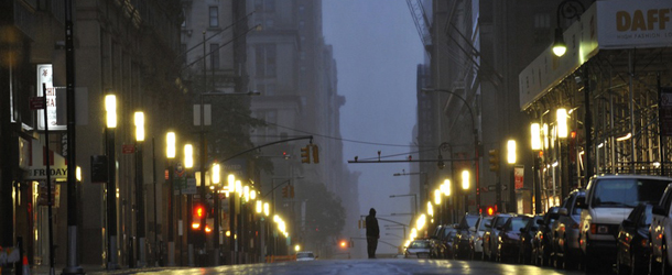 A man stands in the middle of a deserted Broadway in Lower Manhattan, New York, early on August 28, 2011 as Hurricane Irene hits the city and Tri State area with rain and high winds. New York City resembled a ghost town after 370,000 people were told to evacuate flood-prone areas, including near Wall Street and at Coney Island, and mass transport was shut down. AFP PHOTO / Stan HONDA (Photo credit should read STAN HONDA/AFP/Getty Images)