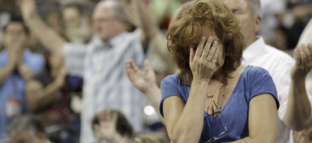 A woman prays at The Response, a call to prayer for a nation in crisis, Saturday, Aug. 6, 2011, in Houston. Texas Gov. Rick Perry attended the daylong prayer rally despite criticism that the event inappropriately mixes religion and politics. (AP Photo/David J. Phillip)