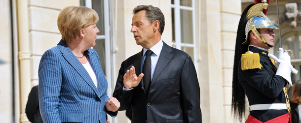 France's President Nicolas Sarkozy (C) welcomes German Chancellor Angela Merkel(L) as she arrives for a meeting on debt crisis on August 16, 2011 at the Elysee presidential palace in Paris. Merkel and Sarkozy lead the 17-nation eurozone's two biggest economies and markets have been watching anxiously to see whether they would agree a plan to boost confidence and tame an unprecedented sovereign debt crisis. AFP PHOTO POOL PHILIPPE WOJAZER (Photo credit should read PHILIPPE WOJAZER/AFP/Getty Images)