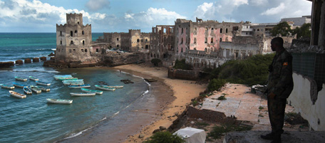 MOGADISHU, SOMALIA - AUGUST 17: A Ugandan African Union (AMISOM) soldier looks out to the Indian Ocean from the formerly five-star and war-ravaged Uruba Hotel on August 17, 2011 in Mogadishu, Somalia. After more than two decades of civil war, the UN estimates that 1.5 million Somalis are displaced within the country and more than 100,000 of them have fled to Mogadishu in the last months due to famine and drought. (Photo by John Moore/Getty Images)