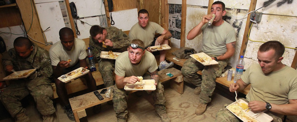 OBSERVATION POST MUSTANG, AFGHANISTAN - SEPTEMBER 02: U.S. Army soldiers from the 2-27th Infantry Regiment eat dinner inside Observation Post Mustang on September 2, 2011 in Kunar Province, Afghanistan. The area, in northeastern Afghanistan near the Pakistan border, is considered a major infiltration route by Taliban fighters coming across from Pakistan and has seen some of the heaviest fighting of the war. (Photo by John Moore/Getty Images)