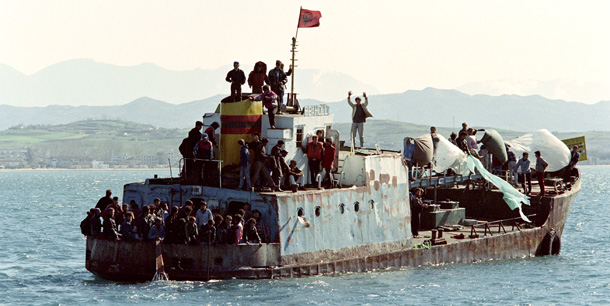 About fifty Albanians attempt to flee on an abandoned cargo boat that has no engine by drifting and using sheets of plastic as sails on March 18, 1997, from the port of Durres to Italy. In the early 1990s, deliberate programs of economic and democratic reform were put in place, but Albanian inexperience with capitalism led to the proliferation of pyramid schemes - which were not banned due to the corruption of the government. Anarchy in late 1996 to early 1997, as a result of the collapse of these pyramid schemes, alarmed the world. The state institutions collapsed and an EU military mission led by Italy was sent to stabilize the country. AFP PHOTO ERIC CABANIS (Photo credit should read ERIC CABANIS/AFP/Getty Images)