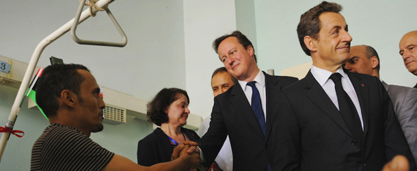 British Prime Minister David Cameron, center, and French President Nicolas Sarkozy, right, meet patients at the Tripoli Medical Center in Tripoli, Libya Thursday Sept. 15, 2011. British Prime Minister David Cameron and French President Nicolas Sarkozy arrived in Tripoli on Thursday _ the first heads of government to visit Libya since revolutionary forces seized the capital, a major endorsement for the North African nation&#8217;s new rulers. (AP Photo/Stefan Rousseau, Pool)
