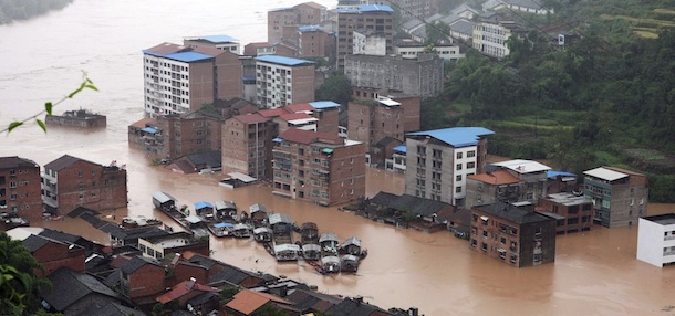 In this photo taken Monday, Sept. 19, 2011, boats are gathered in the midst of a flooded section of the town in Daxian county in southwest China&#8217;s Sichuan province. Chinese state media say dozens of people have died in the latest flooding triggered by heavy rains in southwestern China. (AP Photo) CHINA OUT
