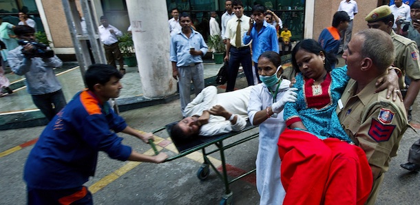 An Indian policeman carries a wounded blast victim at the RML Hospital in New Delhi on September 7, 2011, following a bomb blast at the Delhi High Court. A bomb blast ripped through a crowded reception area at the entrance to New Delhi's High Court in the morning, killing at least nine people and injuring up to 40, police said. Police said the bomb had apparently been placed in a suitcase near the reception where scores of petitioners were queuing for their entry passes to the court complex, situated in the centre of the Indian capital. AFP PHOTO/ MANAN VATSYAYANA (Photo credit should read MANAN VATSYAYANA/AFP/Getty Images)