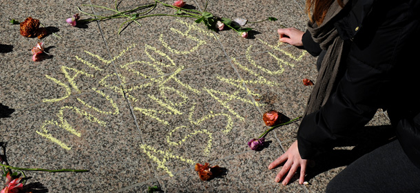 A protester writes 'Jail Murdoch - Not Assange' in reference to the case of Australian WikiLeaks founder Julian Assange, on the ground outside the offices of Rupert Murdoch's Herald Sun newspaper during a protest in Melbourne on July 27, 2011. The protest called for an investigation in Murdoch's Australian newspaper interests, News Ltd, after the News of the World phone hacking scandal in England. AFP PHOTO/William WEST (Photo credit should read WILLIAM WEST/AFP/Getty Images)