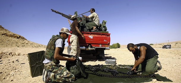 Libyan fighters loyal to the National Transitional Council (NTC) load new ammunition at an outpost in Wadi Dinar in the area along the frontline with the town of Bani Walid on September 11, 2011. Libya's new rulers were poised to launch a final assault on towns still loyal to Moamer Kadhafi a day after a deadline expired for their peaceful surrender. AFP PHOTO/JOSEPH EID (Photo credit should read JOSEPH EID/AFP/Getty Images)