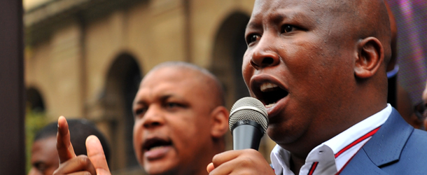 The youth leader of South Africa&#8217;s ruling party, Julius Malema, addresses the crowd outside the court in Johannesburg on April 21, 2011, following the trial over an anti-apartheid struggle song. Malema said that singing &#8220;shoot the farmer&#8221; does not incite violence, during a hate speech trial that has, captivated the nation. The trial over the anti-apartheid struggle song has ignited a national debate over how to remember South Africa&#8217;s past. After his two-day grilling, Malema told his supporters outside the court &#8212; watching him testify on big screen television set up by the youth league &#8212; &#8220;that the African National Congress (ANC) was blamed for teaching its supporters liberations songs.&#8221; AFP PHOTO / ALEXANDER JOE (Photo credit should read ALEXANDER JOE/AFP/Getty Images)
