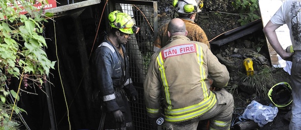Image released by South Wales Police on Thursday Sept 15 2011 of emergency workers at the scene in Gleision Colliery near Swansea, South Wales, where four men are trapped following structural damage. Rescuers said they had not been able to contact the men, trapped 300 feet (90 meters) underground , and it wasn&#8217;t immediately clear what condition they were in or what caused the mine to flood. (AP Photo/ Carl Ryan/South Wales Police) NO SALES
