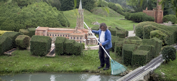 A worker cleans water next to a miniature replica of Saint-Sernin Basilic, located in Toulouse in the Haute-Garonne region, at the &#8216;France Miniature&#8217; leisure Park on July 29, 2011 in Elancourt, a western Paris suburb. The park, celebrating this year its 20th anniversary, covers 5 hectares with France&#8217;s regional landscapes and 116 historical monuments at the exact replicas on a 1/30 scale. AFP PHOTO / JOEL SAGET (Photo credit should read JOEL SAGET/AFP/Getty Images)
