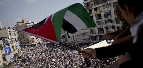 A girl waves a Palestinian flag during a rally in support of the Palestinian bid for statehood recognition in the United Nations, in the West Bank city of Ramallah, Wednesday, Sept. 21, 2011. Thousands of flag-waving Palestinians rallied Wednesday in towns across the West Bank to show support for their president&#8217;s bid to win U.N. recognition of a Palestinian state. (AP Photo/Tara Todras-Whitehill)
