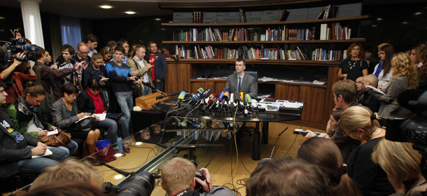 Russian tycoon Mikhail Prokhorov, center, head of the Right Cause party, speaks to the media in his office in Moscow on Wednesday, Sept. 14, 2011. Prokhorov said he would not quit as the leader of the Right Cause party despite speculation.(AP Photo/Ivan Sekretarev)
