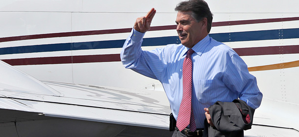 Republican presidential candidate, Texas Gov. Rick Perry waves while arriving at Midland Airpark in Midland, Texas Thursday, Sept. 1, 2011, for a private fundraising event at oilman Clayton Williams' home, his eighth stop on a fundraising tour. (AP Photo/Odessa American, Heather Leiphart)