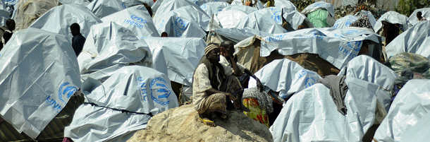 Displaced Somali men sit amongst makeshift tarpaulin shelters on August 31, 2011 at an IDP (internally displaced persons) camp in Somalia's capital Mogadishu, a country in which an estimated 1.5 million people have been displaced. UN refugee agency chief Antonio Guterres said on August 30, that relief groups should increase aid to war-battered and drought-hit Somalis to reduce the exodus to neighbouring countries. 
AFP PHOTO/Tony KARUMBA (Photo credit should read TONY KARUMBA/AFP/Getty Images)