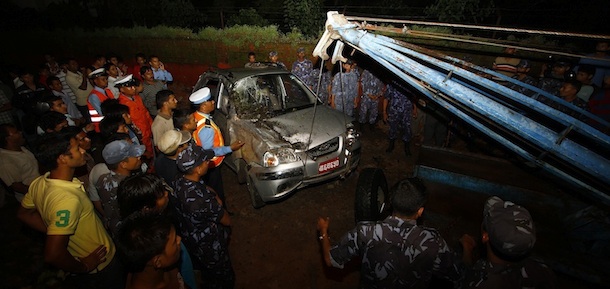 Neplaese rescue workers remove a damaged car after the British Embassy&#8217;s compound wall collapsed reportedly killing three pedestrians following an earthquake in Katmandu, Nepal, Sunday, Sept. 18, 2011. A strong earthquake with a preliminary magnitude of 6.8 hit northeastern India on Sunday near the border with Nepal. Reports said several people were injured and some buildings fell in the capital of India&#8217;s Sikkim state. In neighboring Nepal and Bangladesh, the quake sent residents rushing out their homes, offices and shopping centers. (AP Photo/Niranjan Shrestha)

