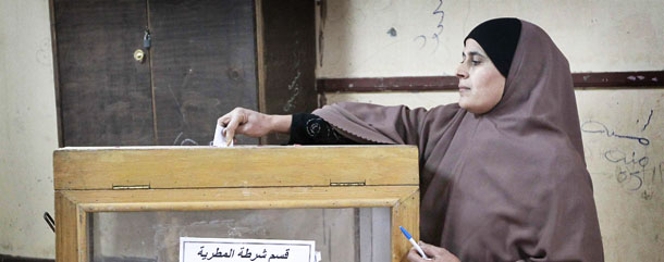 An Egyptian woman casts her vote at a polling station in Al-Matariya district in Cairo on December 5, 2010 as Egypt holds second-round runoffs in a parliamentary election that the ruling party is poised to win almost unopposed in the face of an opposition boycott. AFP PHOTO / KHALED DESOUKI (Photo credit should read KHALED DESOUKI/AFP/Getty Images)
