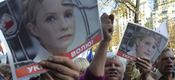 Supporters of former Ukrainian Prime Minister Yulia Tymoshenko shouts slogans outside the Pecherskiy District Court in Kiev, Tuesday, Sept. 27, 2011. The trial of former Ukrainian Prime Minister Yulia Tymoshenko resumed Tuesday after being abruptly put on hold for two weeks. The poster with Tymoshenko reads: &#8216; Freedom of Ukraine &#8216;(AP Photo/Sergei Chuzavkov)
