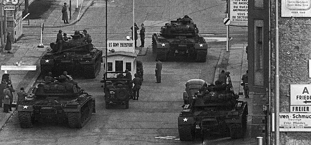 U.S. Army tanks, foreground, at Checkpoint Charlie, and Soviet Army tanks, opposite, face each other in the most dangerous of several crises at the Friedrichstrasse checkpoint in Berlin during the Cold War, Oct. 28, 1961. The armor remained in position for more than 16 hours at one of the few crossing points in the wall that divided Communist East Berlin and West Berlin. The Russians retreated to a ruined royal palace while the Americans moved to a bombed site. (AP Photo/Kreusch)
