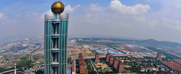 This aerial photo taken on September 25 shows the Longxi International Hotel, standing at 328 metres (1,082-feet) high and costing 470 million USD to build, in Huaxi, which is still classed as a village in east China&#8217;s Jiangsu province. One of China&#8217;s tallest buildings has opened for business in the nation&#8217;s &#8216;wealthiest village&#8217; of Huaxi, a symbol of the country&#8217;s breakneck economic growth, officials and state press said on October 10, 2011. CHINA OUT AFP PHOTO (Photo credit should read STR/AFP/Getty Images)
