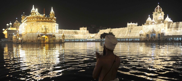 Indian Sikh devotees pay their respects at the illuminated Golden Temple on the eve of the festival of Diwali in Amritsar on October 25, 2011. Indians throughout the country are preparing to celebrate Diwali on October 26. AFP PHOTO/ NARINDER NANU (Photo credit should read NARINDER NANU/AFP/Getty Images)

