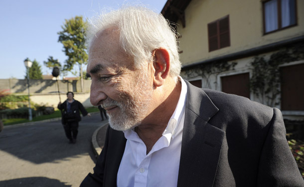 Former IMF chief Dominique Strauss-Kahn (C) answers journalists&#8217; questions after voting for the second round of French Socialist party (PS) primary vote for France&#8217;s 2012 presidential election on October 16, 2011 in Sarcelles, northern suburb of Paris. Facing off for the prize are 57-year-old lawmaker and former Socialist Party chief Francois Hollande, the frontrunner, and Martine Aubry, another party leader who gave France the 35-hour working week when labour minister. Hollande won the first round of the primary vote last October 9, with 39 percent, and had previously been endorsed by the three other defeated candidates, including his former partner, 2007 presidential candidate Segolene Royal. Aubry came second with 30 percent but was expected to pick up many of the votes cast for Montebourg by appealing to the left-wing base of the party. AFP PHOTO THOMAS SAMSON (Photo credit should read THOMAS SAMSON/AFP/Getty Images)
