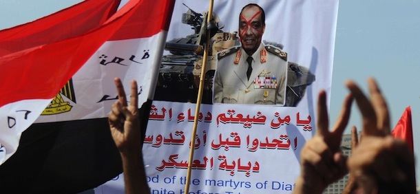 Egyptian protesters hold a banner against Field Marshal Hussein Tantawi as they gather in Cairo&#8217;s Tahrir Square on September 30, 2011 during a mass rally to reclaim the revolution amid anger over the military rulers&#8217; handling of the transition. AFP PHOTO/MOHAMMED HOSSAM (Photo credit should read MOHAMMED HOSSAM/AFP/Getty Images)

