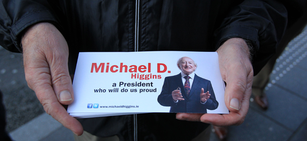 A supporter hands out Labour&#8217;s presidential candidate Micheal D Higgins leaflets in Kilkenny on October 25, 2011 during his final two days of canvassing. Irish voters go to the polls on October 27 to elect a new President. AFP PHOTO / PETER MUHLY (Photo credit should read PETER MUHLY/AFP/Getty Images)
