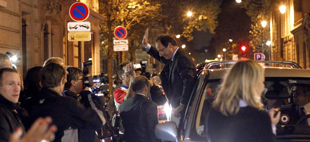 Francois Hollande (C), winner of the Socialist Party (PS) 2011 primary vote for France&#8217;s 2012 presidential, waves to supporters upon his arrival at the party&#8217;s headquarters after the second round of the vote, on October 16, 2011 in Paris. The frontrunner in the French left&#8217;s primary to choose a presidential candidate, Francois Hollande, enjoyed a comfortable lead today with 57 % of votes against Martine Aubry in the run-off. AFP PHOTO THOMAS COEX (Photo credit should read THOMAS COEX/AFP/Getty Images)
