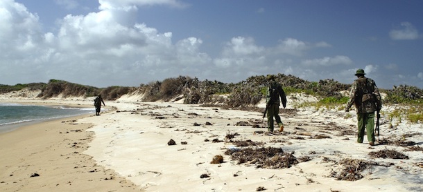 Armed police men patrol a stretch of beach near Kiwayu Safari village on September 12, 2011 where holidaying British couple David and Judith Tebbutt were attacked early September 11 by suspected Somalia based Al-Shabab militia ending in the fatal shooting of David and the kidnapping of Judith. David and Judith Tebbutt from the town of Bishop&#8217;s Stortford in southeast England had been staying at the tourist lodge in the Kiunga marine reserve on the Lamu archipelago off Kenya&#8217;s northern coast, one of Kenya&#8217;s top luxury holiday destinations and favoured by celebrities, despite being close to the border with war-torn and drought-stricken southern Somalia. AFP PHOTO/ WILLIAM DAVIES (Photo credit should read WILLIAM DAVIES/AFP/Getty Images)
