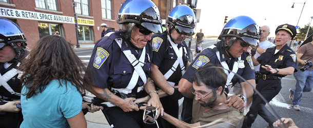 A protestor who are part of the &#8220;Occupy Boston&#8221; group is led off by police during a stand off with Boston Police at the Charlestown Bridge in Boston, Monday afternoon, Oct. 10, 2011. (AP Photo/Josh Reynolds
