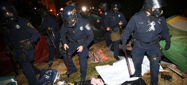 Oakland police search tents in Frank Ogawa Plaza as they disperse Occupy Oakland protesters on Tuesday, Oct. 25, 2011 in Oakland, Calif. City officials had originally been supportive of the protesters, but the city later warned the protesters that they were breaking the law and could not stay in the encampment overnight. (AP Photo/Bay Area News Group, Jane Tyska)
