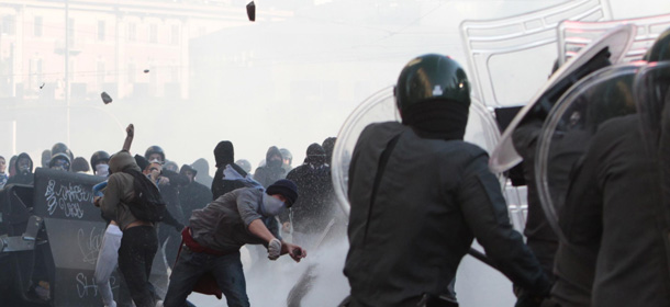 In this picture taken Saturday, Oct. 15, 2011, protesters clash with police in downtown Rome. Protesters in Rome smashed shop windows and torched cars as violence broke out during a demonstration in the Italian capital, part of worldwide protests against corporate greed and austerity measures. The &#8220;Occupy Wall Street&#8221; protests, that began in Canada and spread to cities across the U.S., moved Saturday to Asia and Europe, linking up with anti-austerity demonstrations that have raged across the debt-ridden continent for months. (AP Photo/Gregorio Borgia)
