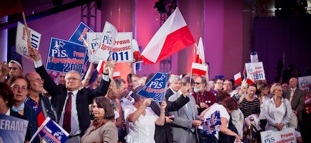 Supporters of the conservative Law and Justice party hold signs and flags as they attend a party convention at the Palace of Culture in Warsaw, on October 2, 2011. AFP PHOTO / WOJTEK RADWANSKI (Photo credit should read WOJTEK RADWANSKI/AFP/Getty Images)
