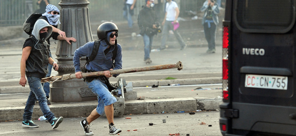 Protesters attack a Police vehicule during a demonstration in Rome on October 15, 2011. Tens of thousands marched in Rome today as part of a global day of protests inspired by the &#8220;Occupy Wall Street&#8221; and &#8220;Indignant&#8221; movements, with the Italian capital under a security lockdown. Protesters launched worldwide street demonstrations on October 15 against corporate greed and biting cutbacks in a rolling action targetting 951 cities in 82 countries. AFP PHOTO / ALBERTO PIZZOLI (Photo credit should read ALBERTO PIZZOLI/AFP/Getty Images)
