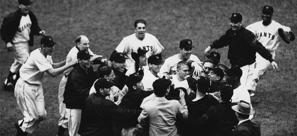 New York Giant players and fans converge on Bobby Thomson (head being rubbed) to reward him with a mauling after his pennant-winning, three-run homer in ninth inning of third playoff game with the Brooklyn Dodgers at the Polo Grounds in New York on Oct. 3, 1951. Running in at left is Ed Stanky and trying to get to Thomson is manager Leo Durocher (hatless, third from left). In center background is Freddy Fitzsimmons, coach, and at top right is center fielder Willie Mays. Final score of 5-4 clinched the National League pennant for Giants over Dodgers whom they trailed all season. (AP Photo)
