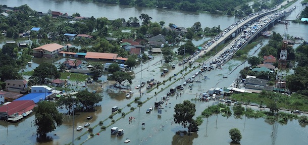 This aerial picture shows cars stranded on a partially-submerged fly-over in the central Thai province of Pathum Thani, on the northern outskirts of Bangkok on October 11, 2011. Massive floods have left 500 people dead across Thailand, Cambodia and Vietnam, officials said, as authorities stepped up efforts to reach victims of the unusually heavy monsoon rains. AFP PHOTO/Christophe ARCHAMBAULT (Photo credit should read CHRISTOPHE ARCHAMBAULT/AFP/Getty Images)
