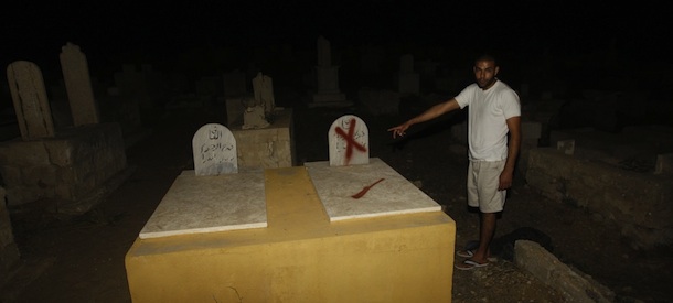 A man looks at tombstones which were vandalized at two cemeteries belonging to Muslims and Christians daubed with the messages âDeath to Arabsâ and âPrice tagâ after they were spray painted on the graves in the Arab city of Jaffa, near Tel Aviv, on October 8, 2011. AFP PHOTO/AHMAD GHARABLI (Photo credit should read AHMAD GHARABLI/AFP/Getty Images)
