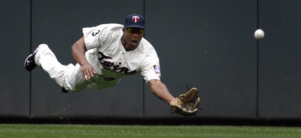 Minnesota Twins center fielder Ben Revere dives for a ball off the bat of Detroit Tigers&#8217; Miguel Cabrera during the first inning of a baseball game Saturday, July 23, 2011 in Minneapolis. Cabrera had a single on the hit. (AP Photo/Tom Olmscheid)
