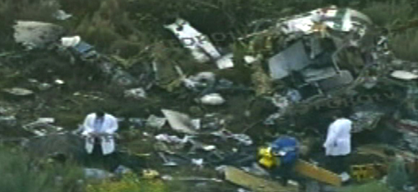In this video frame grab image taken from Televisa&#8217;s Forotv via APTN, investigators examine the wreckage of a helicopter that was carrying Mexico&#8217;s Interior Minister Francisco Blake Mora, in a mountainous area of Mexico state southeast of Mexico City, Friday Nov. 11, 2011. The Mexican government said Friday, that Mora, Mexico&#8217;s No. 2 government official next to the president, died in the helicopter crash with seven others, including the pilot. (AP Photo/Forotv-Televisa via APTN)
