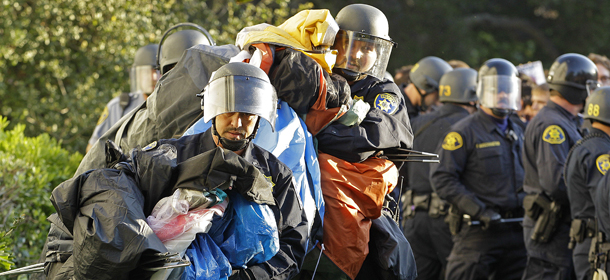 Police in riot gear remove tents in front of Sproul Hall on the University of California at Berkeley campus Wednesday, Nov. 9, 2011, in Berkeley, Calif. Student activists attempted to set up an &#8220;Occupy Cal&#8221; camp on campus despite official warnings that such encampments are not allowed. These activists joined students across California in calling to make banks pay to end cuts to higher education. (AP Photo/Ben Margot)
