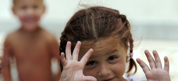 A Rom child shows her hands during a meeting with a humanitarian organization in their camp on the outskirts of Rome on July 7, 2008. A plan by the Italian government to fingerprint undocumented Roma and Sinti has sparked outrage among human rights groups and the EU who warn that identifying people based on ethnicity can set a dangerous precedent. Italian Interior Minister Roberto Maroni, a member of the right-wing Northern League party in Berlusconi&#8217;s centre-right coalition, said the idea behind the census on some 700 camps is part of a broader crackdown on crime to put an end to illegal camps and guarantee security to Italian citizens. AFP PHOTO / FILIPPO MONTEFORTE (Photo credit should read FILIPPO MONTEFORTE/AFP/Getty Images)
