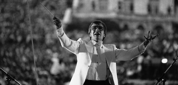 Conductor Maxim Shostakovich, who defected from the Soviet Union, conducts the traditional free Memorial Day concert on the West Lawn of the Capitol Monday, May 25, 1981 in Washington. Shostakovich, in his first performance since he defected, opened with America&#8217;s national Anthem. (AP Photo/Tasnadi)
