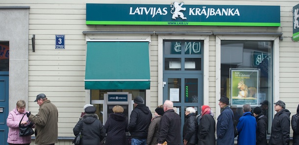 People line up at a cash machine of Latvia&#8217;s Krajbanka bank in Riga on November 23, 2011, a day after Latvia&#8217;s regulators said they had halted &#8220;all financial services&#8221; at Krajbanka and would take over its management, after its Lithuanian-based parent Snoras was put under state administration. The government played down jitters about the banking sector, after regulators suspended operations at the Baltic state&#8217;s sixth-biggest bank, Latvijas Krajbanka. Fifty lats (70 euros) was set as daily limit withdrawal for private customers of the bank. AFP HOTO / ILMARS ZNOTINS (Photo credit should read ILMARS ZNOTINS/AFP/Getty Images)
