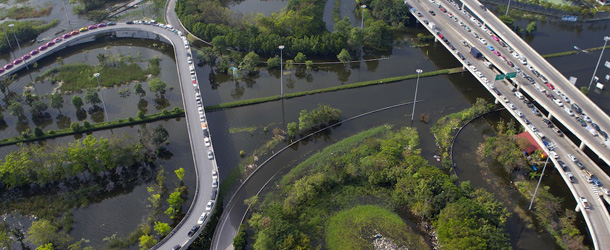 BANGKOK, THAILAND &#8211; NOVEMBER 7: An aerial view of cars parked on a highway in flooded district just outside the capitol city November 7, 2011 in Bangkok, Thailand. Over seven major industrial parks in Bangkok and thousands of factories have been closed in the central Thai province of Ayutthaya and Nonthaburi with millions of tons of rice damaged. Thailand is experiencing the worst flooding in over 50 years which has affected more than nine million people. (Photo by Paula Bronstein/Getty Images)
